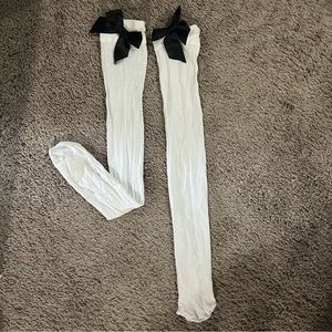 Knee-high white tights with black silk bow